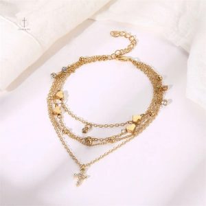 Chaîne de cheville ornée d'une croix stylée